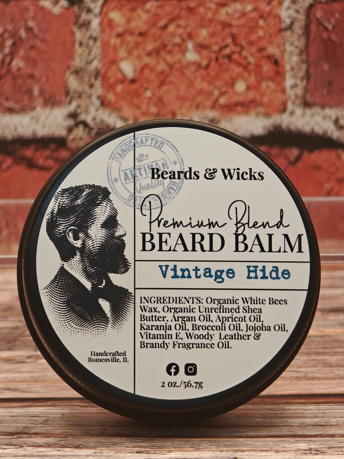 Beards & Wicks Premium Blend Beard Balm in Vintage Hide - 2 oz tin featuring vintage barber illustration, handcrafted in Romeoville, IL with organic ingredients including white beeswax, shea butter, argan oil, and jojoba oil for beard conditioning and styling