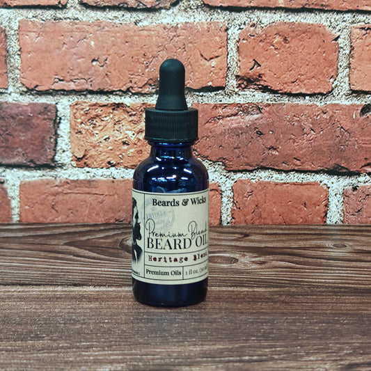 Beards & Wicks' Heritage Blend Premium Beard Oil - 1 oz blue glass dropper bottle with kraft paper label, handcrafted in Romeoville, IL with organic oils including jojoba, argan, and broccoli seed oil for beard nourishment and conditioning