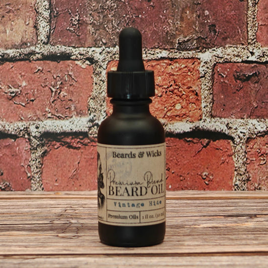 Beards & Wicks' Vintage Hide  Premium Beard Oil - 1 oz black glass dropper bottle with kraft paper label, handcrafted in Romeoville, IL with organic oils including jojoba, argan, and broccoli seed oil for beard nourishment and conditioning