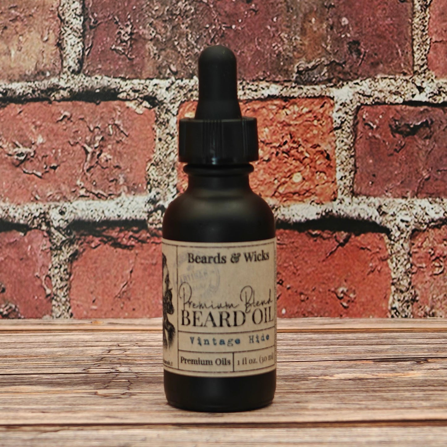 Beards & Wicks' Vintage Hide  Premium Beard Oil - 1 oz black glass dropper bottle with kraft paper label, handcrafted in Romeoville, IL with organic oils including jojoba, argan, and broccoli seed oil for beard nourishment and conditioning